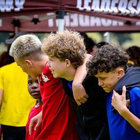 BESA learners with their arms around each other
