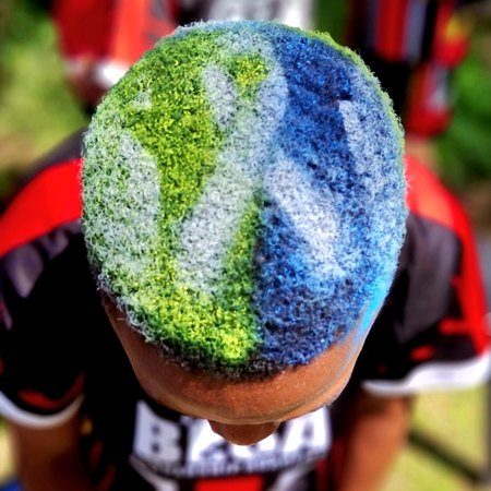 A learner's hair sprayed green and blue at the Shavathon